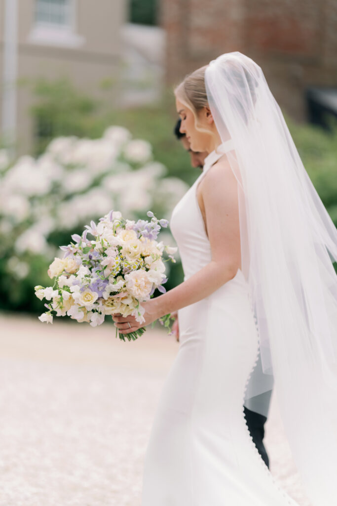 Bride and groom walking together at Burtonfields Hall, romantic wedding photos