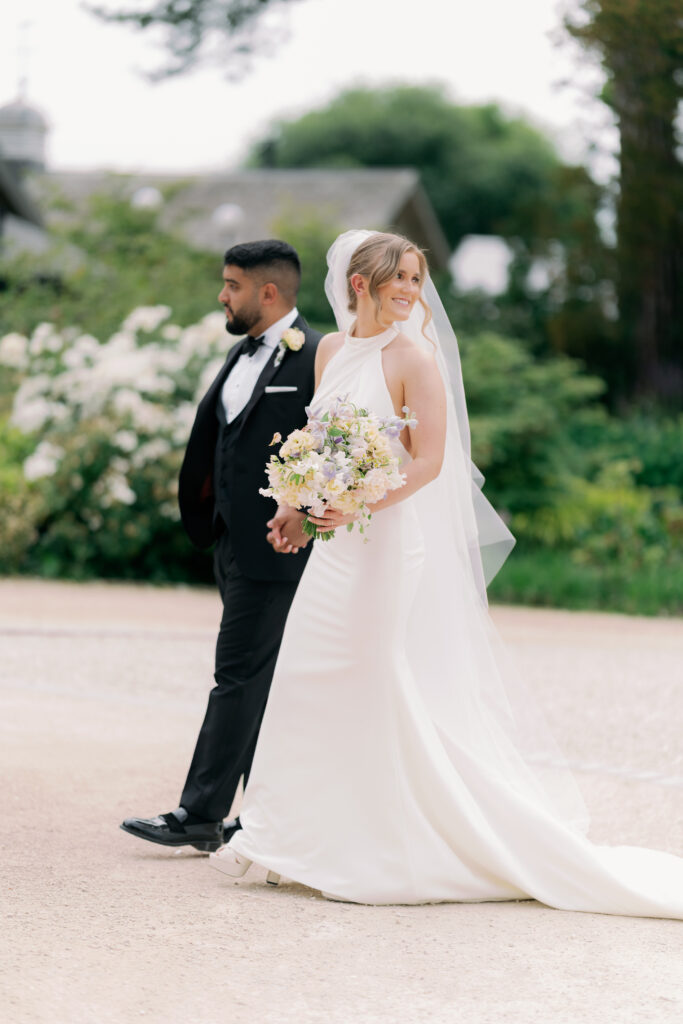 Bride and groom walking together at Burtonfields Hall, romantic wedding photos