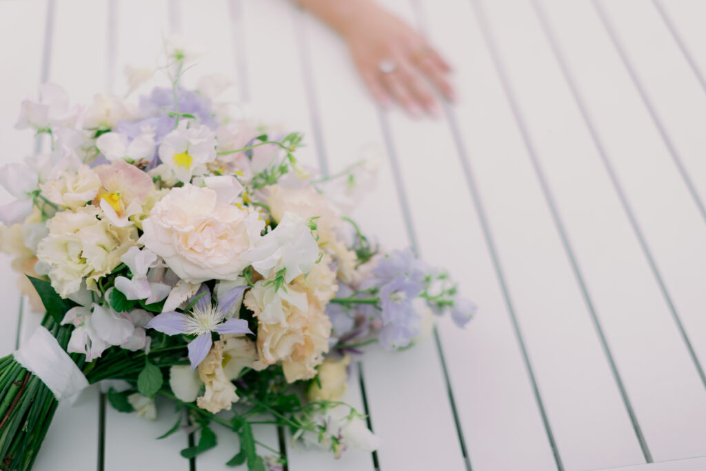 Bride's delicate hands with engagement ring, romantic wedding photography