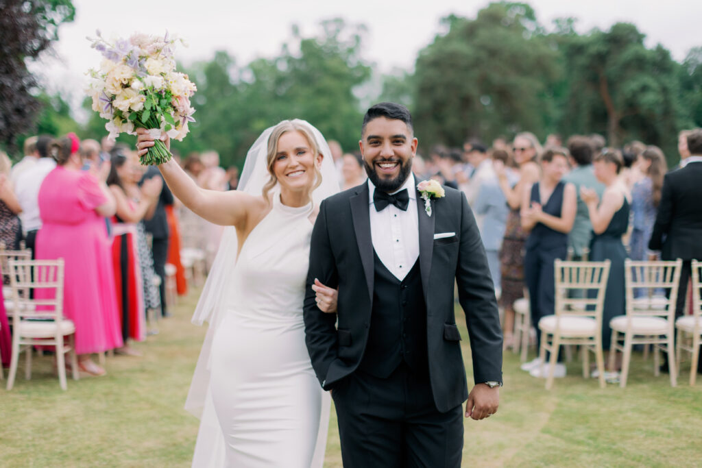 Newlyweds in natural outdoor setting, luxury wedding photography