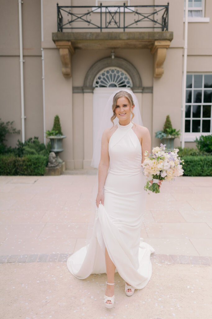 Beautiful bride Natalie in flowing wedding gown at Burtonfields Hall countryside
