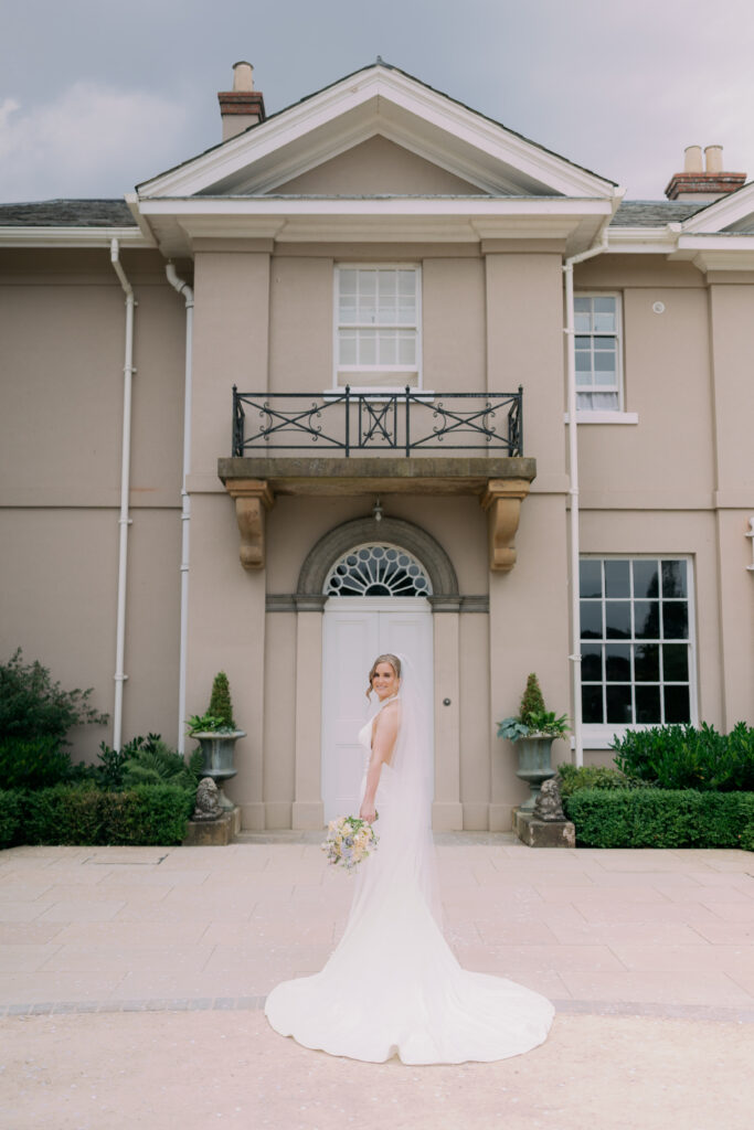Bridal portrait against stone architecture at Burtonfields Hall