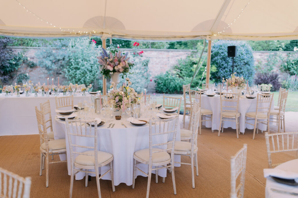 Wedding reception table setting with candles and flowers, timeless wedding details