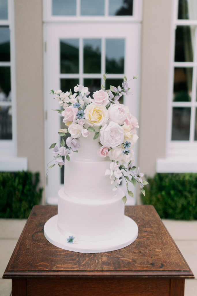 Wedding cake with floral decorations, fine art wedding photography by Camilla Joy