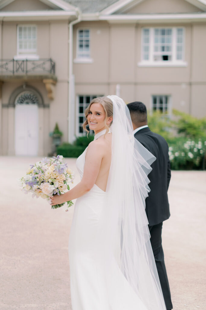 Bride and groom walking together at Burtonfields Hall, romantic wedding photos