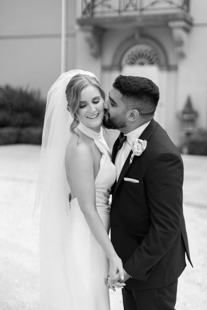 Wedding couple portrait against stone architecture, editorial wedding photography