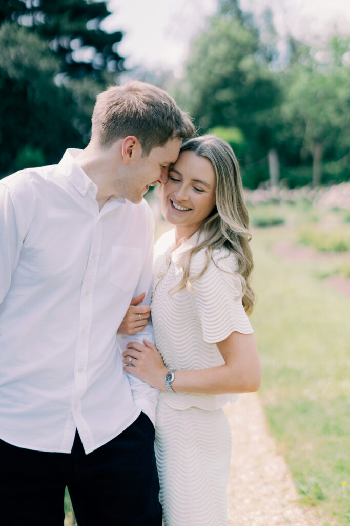 Elegant couple embracing and smiling at Chiswick House London