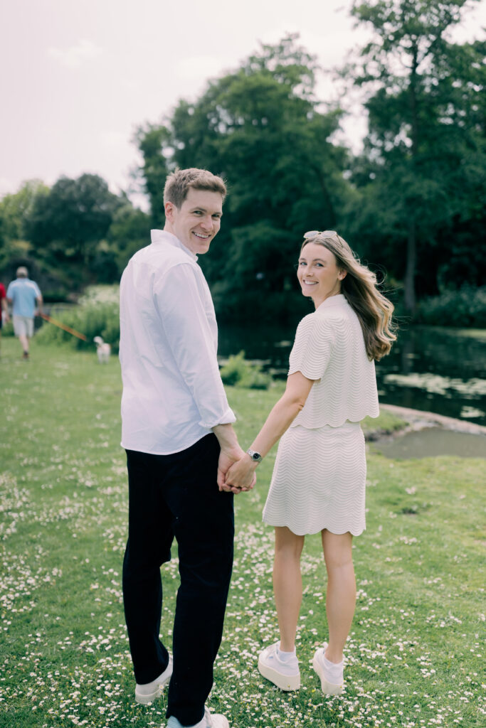 Romantic couple walking hand in hand Chiswick House formal gardens London