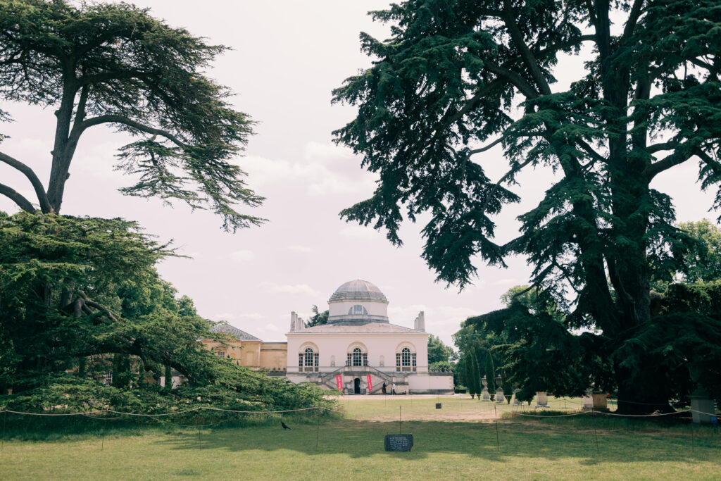 ngagement shoot couple strolling tree-lined paths Chiswick House grounds London