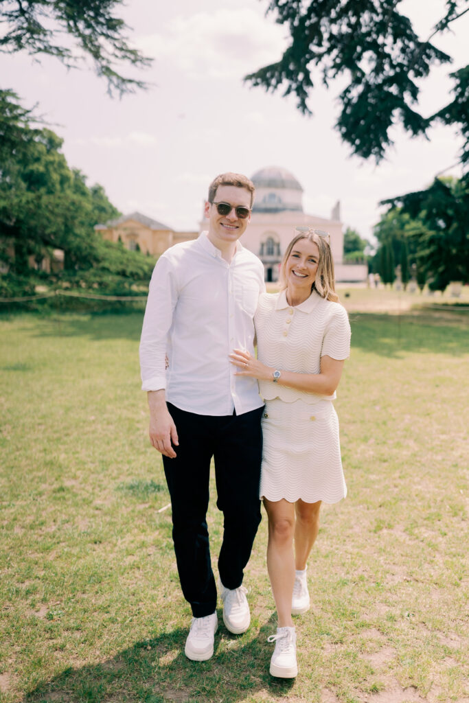 Candid moment engaged couple walking Chiswick House landscape gardens London