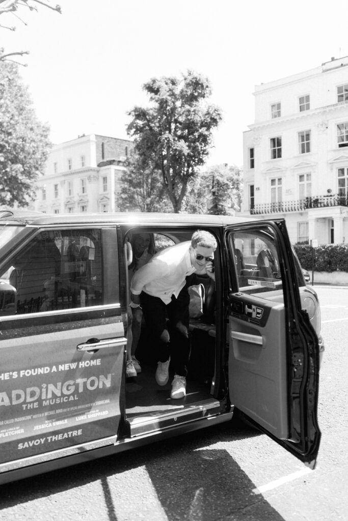 Romantic wedding moment bride groom stepping into vintage wedding car London