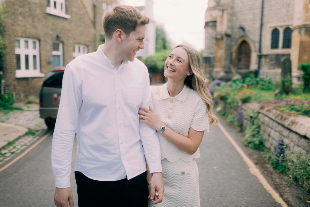 Couple laughing together during spring London engagement photography session
