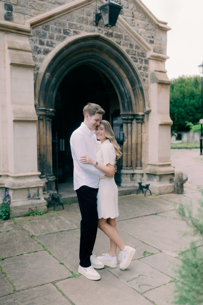 Couple snuggling during engagement shoot in Chiswick