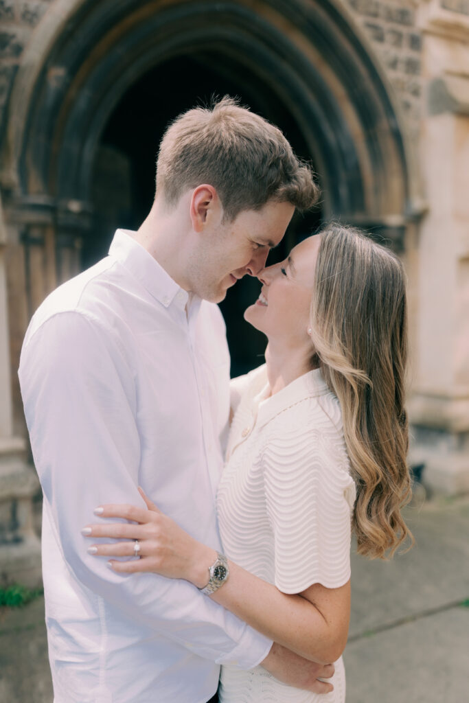 Couple giving eskimo kisses in spring engagement shoot in London