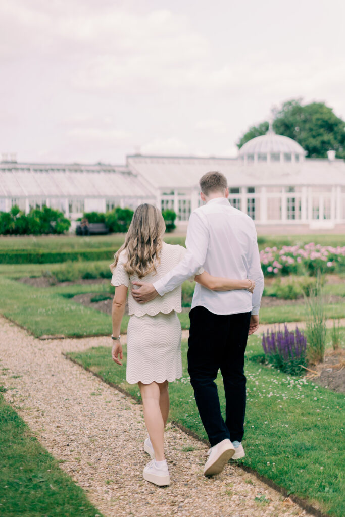 Luxury engagement shoot couple walking through Chiswick House historic grounds London