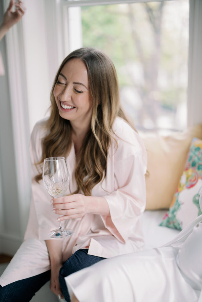 Bridal party sharing gentle laughter during London wedding preparation