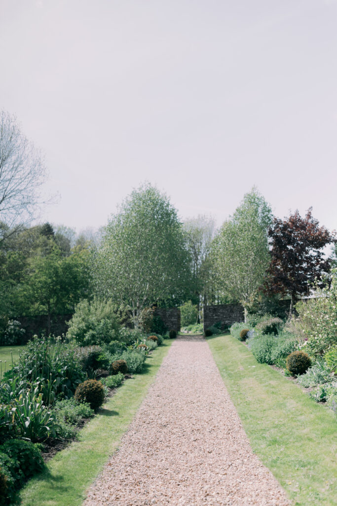 Casterton Grange romantic garden pathway for couple portraits - luxury wedding venue photography by Camilla Joy Photography